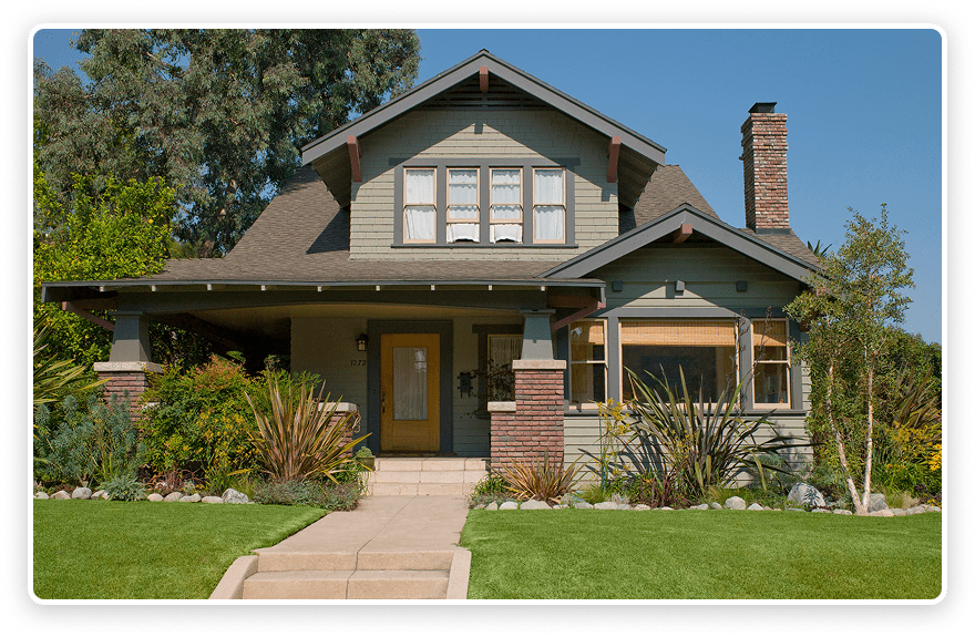 Green lawn leading to cozy family home