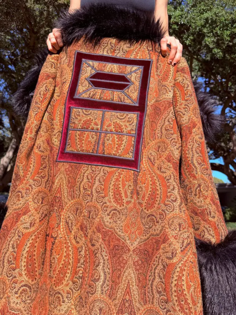 Ornate paisley coat with fur trim and window patch