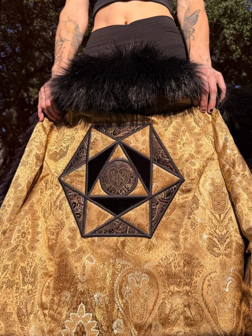 Gold brocade coat with embroidered geometric patch