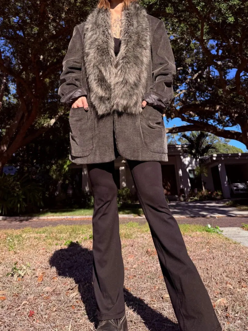Person wearing fur-trimmed corduroy jacket and pants