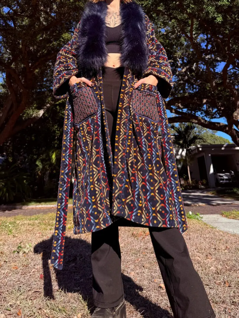 Person wearing multicolored patterned coat with fur
