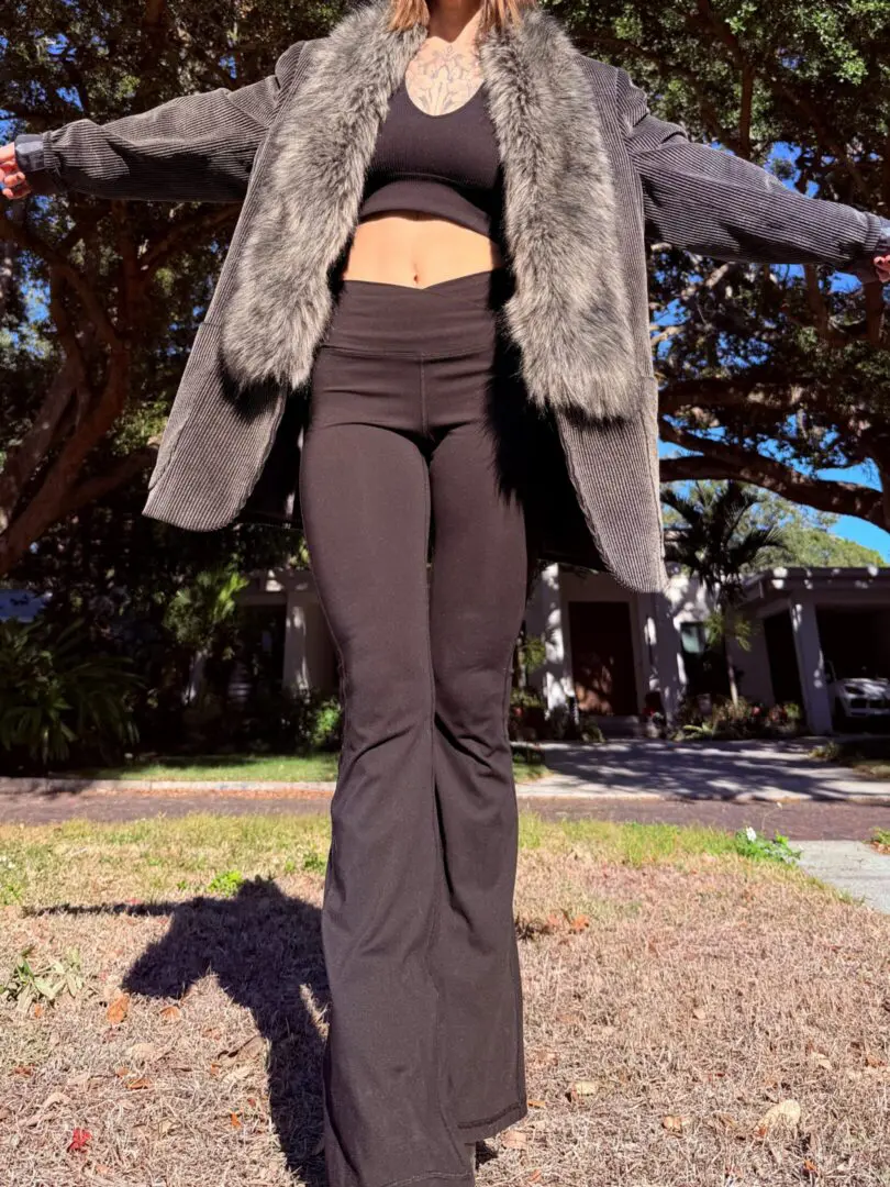 Person in black crop top and fur jacket
