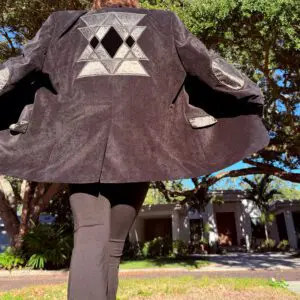 Person wearing black coat with geometric design