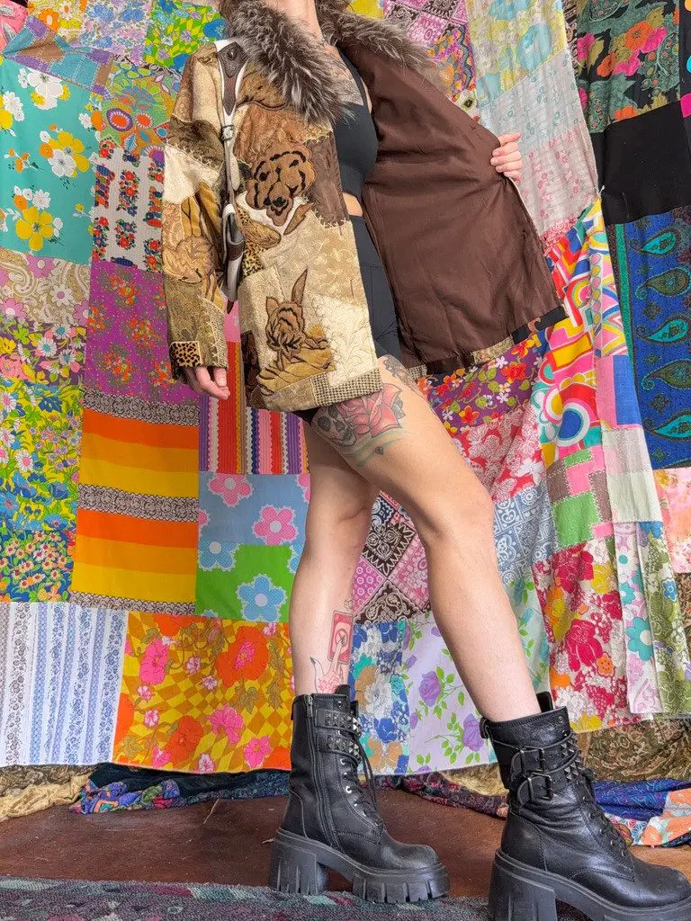 Person wearing fur-collared animal-print coat and boots