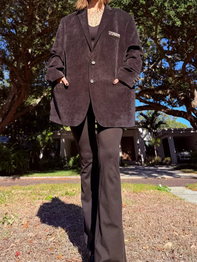 Person wearing oversized black blazer and flared pants