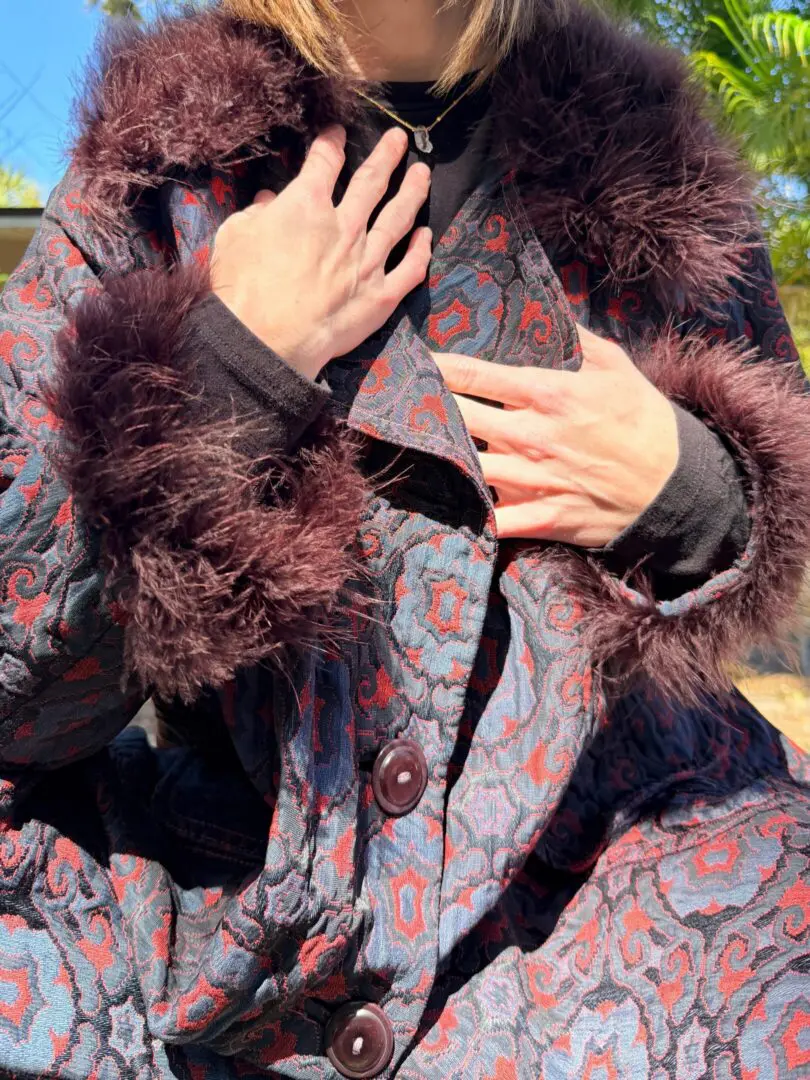 Person wearing patterned fur-trimmed coat
