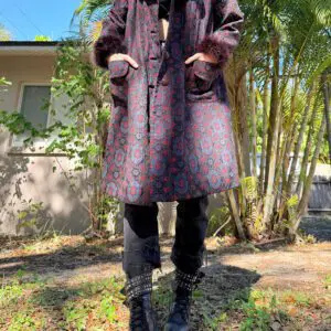 Person wearing patterned coat and chunky boots