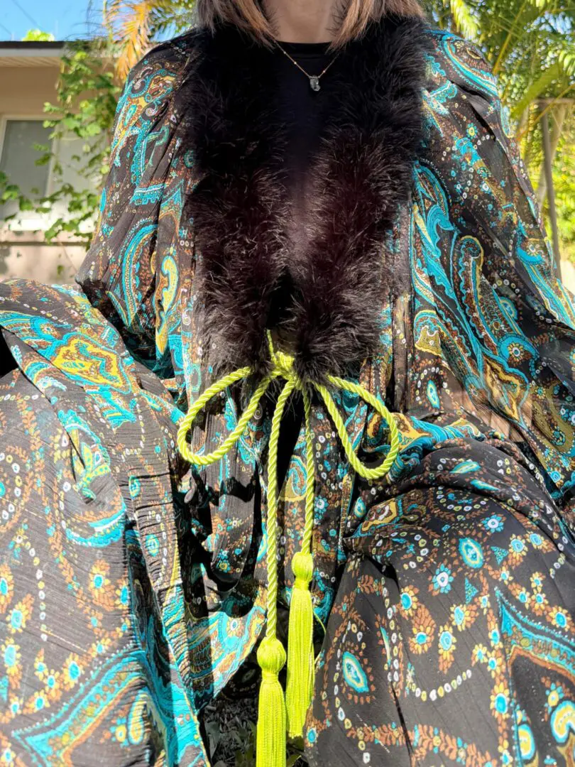 Paisley robe with black fur trim and tassels