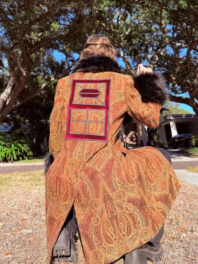 Back view of person in ornate paisley coat