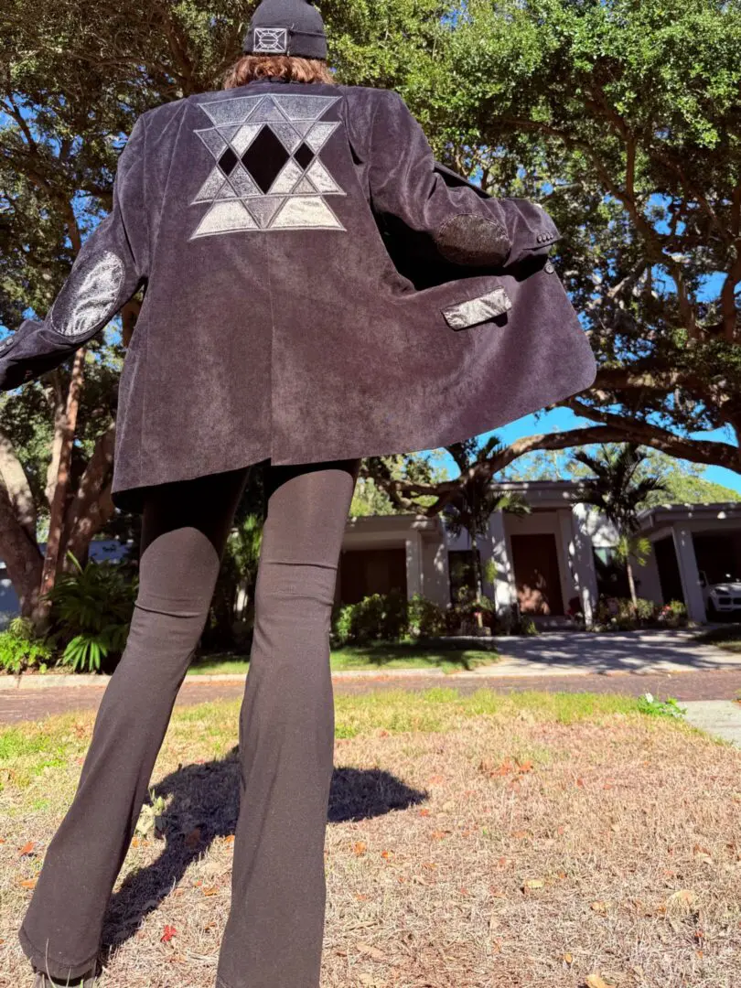 Person wearing black jacket with geometric patch