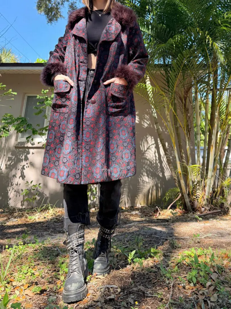 Person wearing patterned coat and chunky boots