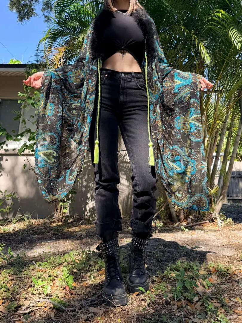 Patterned kimono, cropped top, black jeans, boots