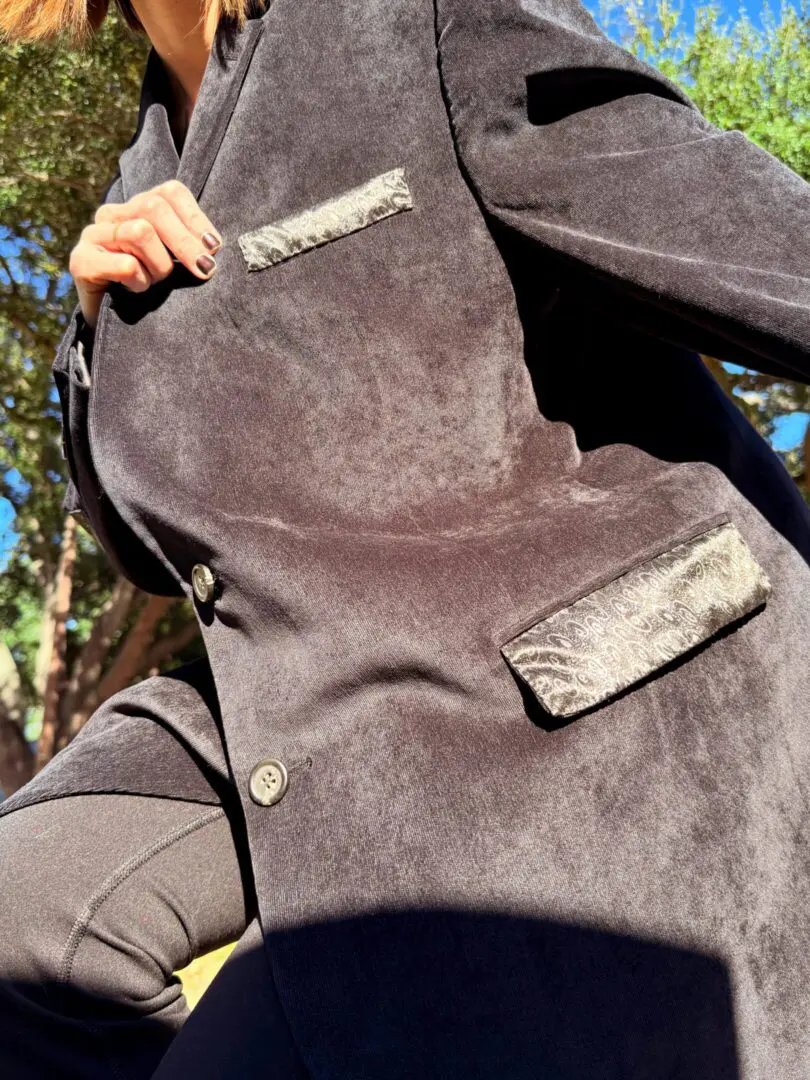 Low-angle close-up of dark suede coat