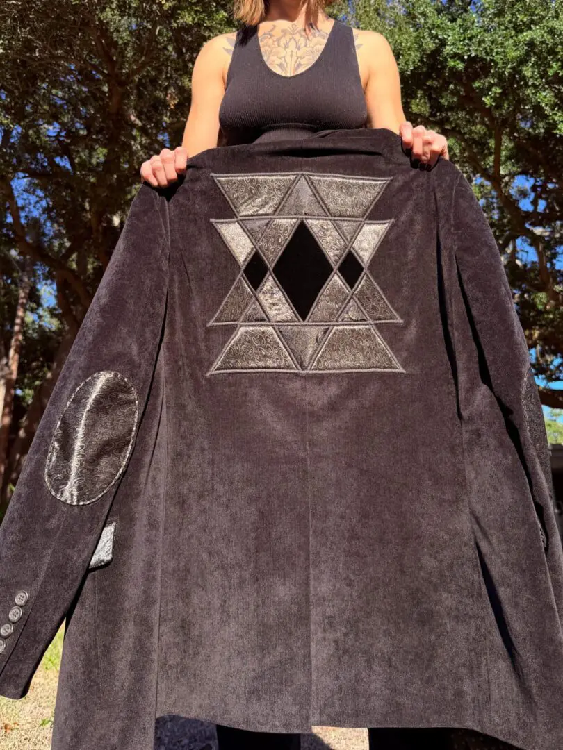 Black coat with geometric star embroidery