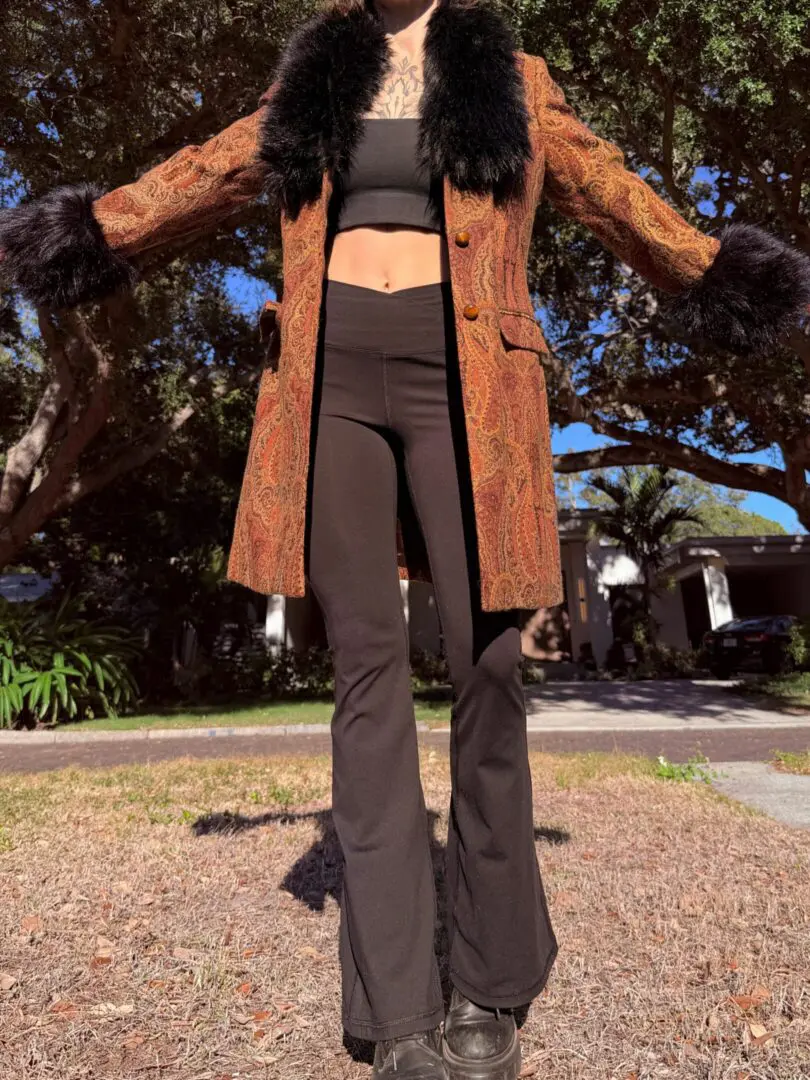 Person wearing paisley coat with fur trim