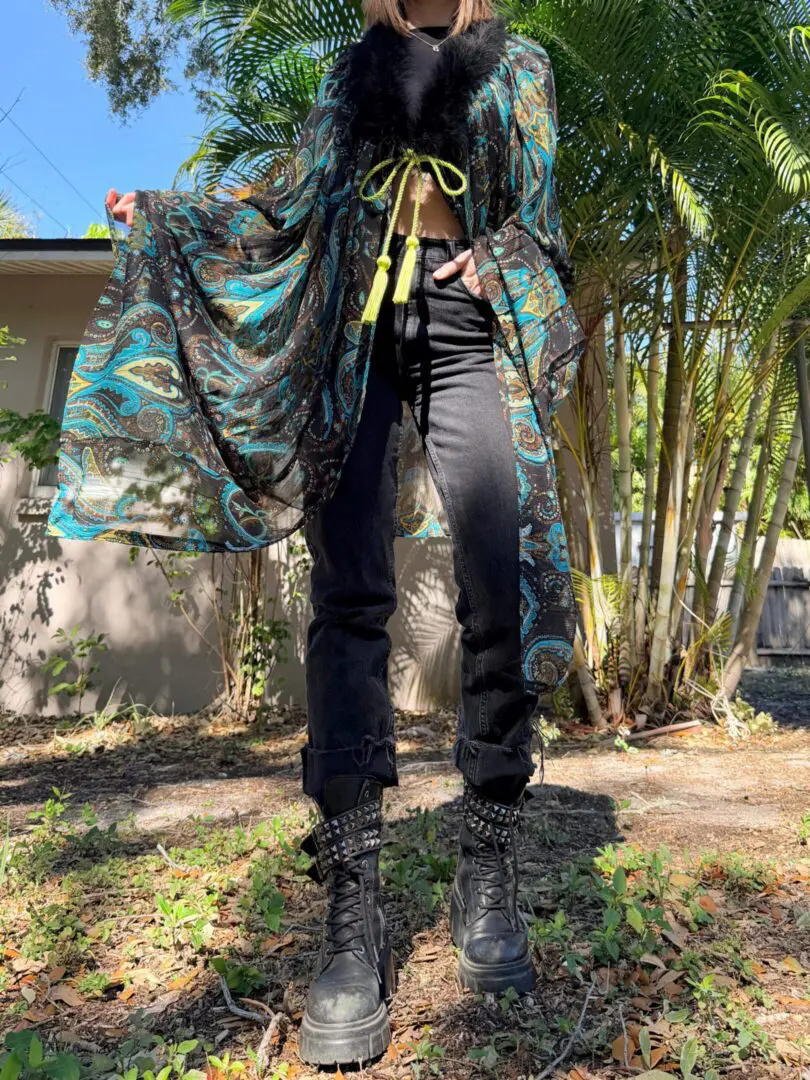Person wearing patterned robe and combat boots