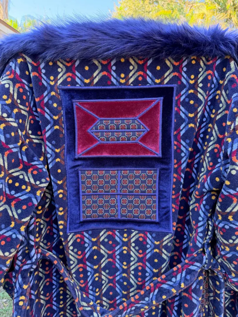 Fur-trimmed blue patterned coat with patches